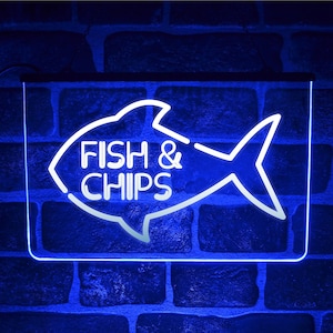 Op de afbeelding: Een blauw neon-bord met een witte omtrek van een vis en de woorden "FISH & CHIPS" in de vis.
