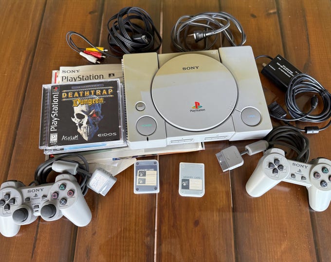 Sony PS1 PlayStation 1 With (2) controllers (4) Ps1 Games (all cables) (papers)