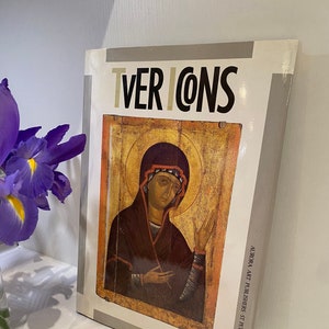 May include: A book titled "Tver Icons" with a painting of a woman in a red robe on the cover. The book is published by Aurora Art Publishers in St. Petersburg.