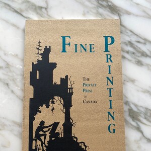 May include: A book cover with the title "Fine Printing" in teal letters. The cover features a black silhouette of a castle and a person working at a printing press. The text "The Private Press in Canada" is also visible.