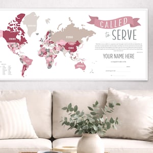 May include: A framed world map in shades of pink, gray, and white, with country names labeled. The text "CALLED to SERVE" is displayed above the map, with space to add a name. The map is displayed above a white couch with pillows.
