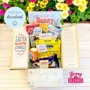 May include: A yellow and blue Easter gift box with the text "Easter is the day that changed everything" and "Some Bunny loves you". The box is filled with various Easter treats, including candy, chocolate, and Peeps.