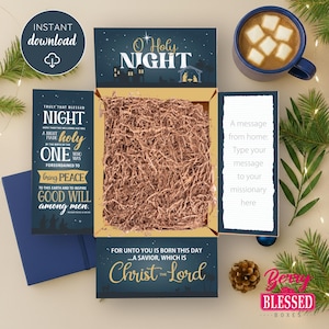 May include: Open gift box with the words "O Holy Night" and "Christ the Lord" printed on it. The box is filled with brown paper and includes a blue notebook, a mug of hot chocolate, and a pine cone. The words "Instant Download" are also visible.