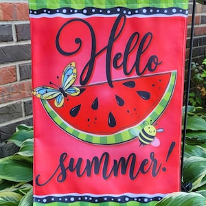 May include: A red garden flag with a watermelon slice, a butterfly, and a bee. The flag has the words "Hello summer!" in black script. The top border is green with white polka dots.