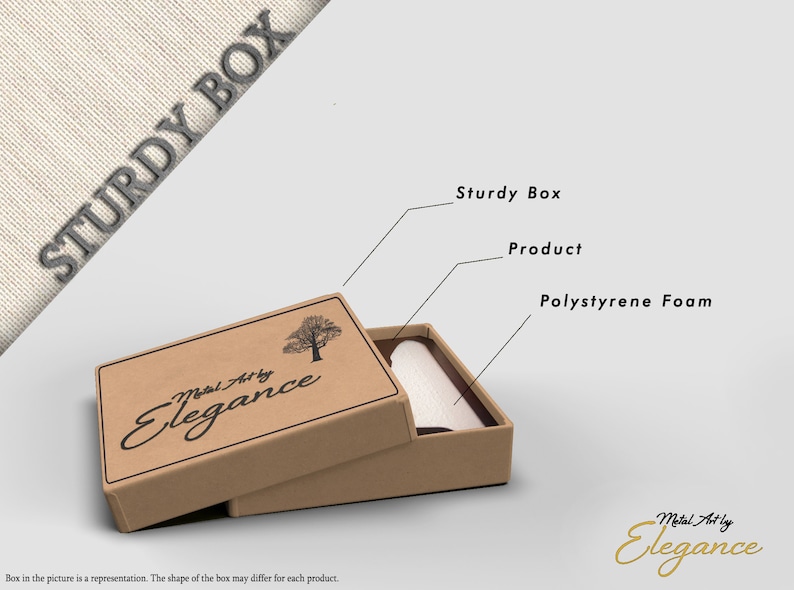 May include: A brown cardboard box with the text "Metal Art by Elegance" and a small tree graphic. The box is open and shows a white product inside, protected by polystyrene foam.