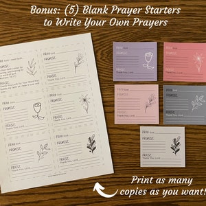 May include: Five printable prayer cards with floral and leaf designs. Each card has sections for "Pray God", "Promise", "Praise", and "Thank You Lord". The cards are in shades of purple, pink, and gray.