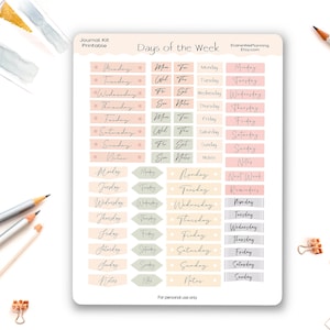 May include: A printable journal kit with stickers for the days of the week. The stickers are in pastel shades of pink, beige, and grey. The text includes the days of the week in a handwritten font. Pencils and paper clips are in the background.