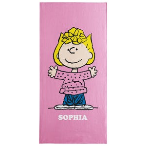 May include: Pink beach towel featuring a cartoon character with yellow hair, a pink dotted shirt, and blue pants. The character has arms outstretched. The name "SOPHIA" is printed in white at the bottom of the towel.