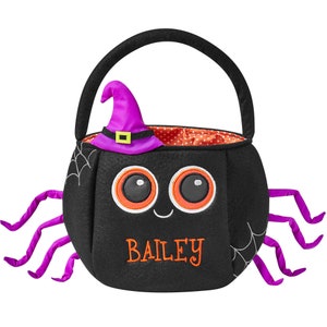 May include: Black Halloween-themed trick-or-treat bag shaped like a spider. The bag has a witch hat, spider legs, and the name "BAILEY" embroidered in orange. The bag has a black handle and a red polka dot interior.