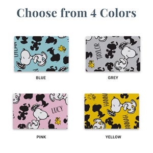 May include: Four rectangular swatches featuring a repeating pattern of Snoopy and Woodstock characters in black silhouettes and white outlines. The backgrounds are blue, grey, pink, and yellow, with personalized names like Dylan, Taylor, Lucy, and Hannah.
