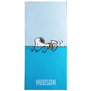 May include: A rectangular beach towel featuring a cartoon illustration of Snoopy swimming in the ocean with a drink. The towel is split into two sections: light blue and turquoise. The word "HUDSON" is printed in white.