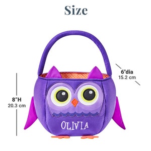 May include: Purple owl-shaped Halloween treat bag with a handle. The bag is 8 inches (20.3 cm) high and 6 inches (15.2 cm) in diameter. Features an owl face with large eyes and the name "OLIVIA" embroidered on the front.