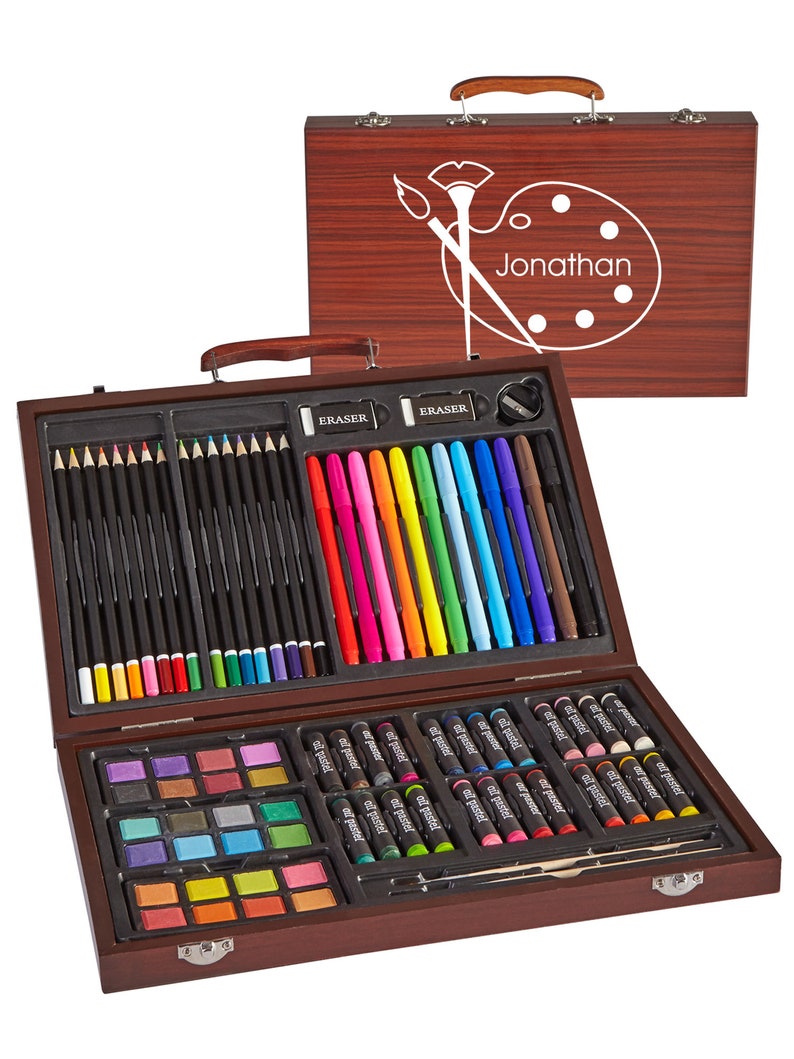 May include: A wooden art set with a personalized name "Jonathan" on the lid. The set includes colored pencils, markers, crayons, watercolor paints, and an eraser.