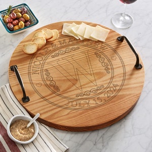 May include: Round wooden serving tray with handles, engraved with the names "Nicole & Matthew", the letter "W", and the date "July 15, 2024".