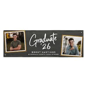 May include: A black graduation banner with two framed photos of a smiling person. The banner has the word "Graduate '26" in white script, along with the name "Brent Hastings" and "Riverdale North High School."