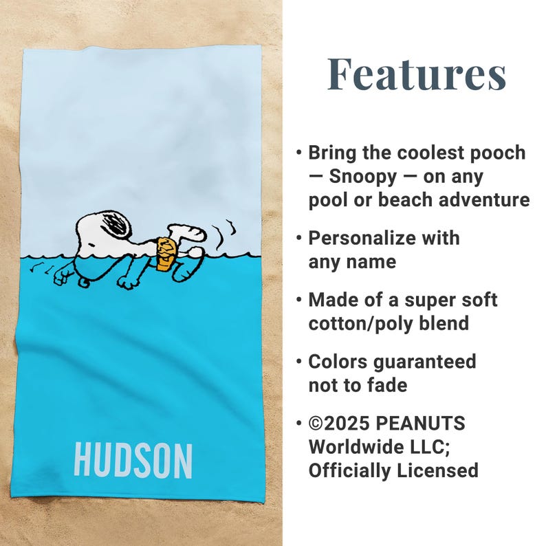 May include: A blue and white beach towel featuring Snoopy swimming in water. The towel has the name "HUDSON" printed in white at the bottom. The text "Features" and other details are on the right side.