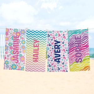 May include: Four colorful beach towels with different patterns and names: "JASMINE", "HAILEY", "AVERY", and "SOPHIE".