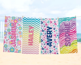 May include: Four colorful beach towels with different patterns and names: "JASMINE", "HAILEY", "AVERY", and "SOPHIE".