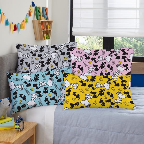 May include: Four decorative throw pillows with a black and white cartoon character design. The pillows are in different colors: gray, pink, blue, and yellow. The names "Preston", "Connor", "Claire", and "Zoey" are printed on the pillows.