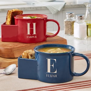 May include: Two personalised soup mugs with side compartments for crackers or bread. The red mug has the letter "H" and the name "HARPER" printed on it. The blue mug has the letter "E" and the name "ELLIJAH" printed on it.