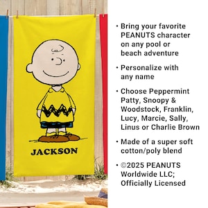 May include: Yellow beach towel featuring Charlie Brown from Peanuts. The towel has a large image of Charlie Brown in his signature outfit, with the name "JACKSON" printed below. The towel is made of a soft cotton/poly blend.