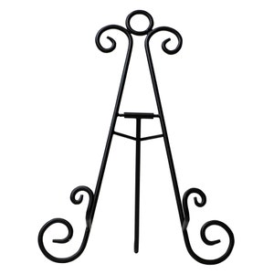 May include: Black metal easel stand with decorative scrollwork details. The stand is designed to hold a plate or other flat object.