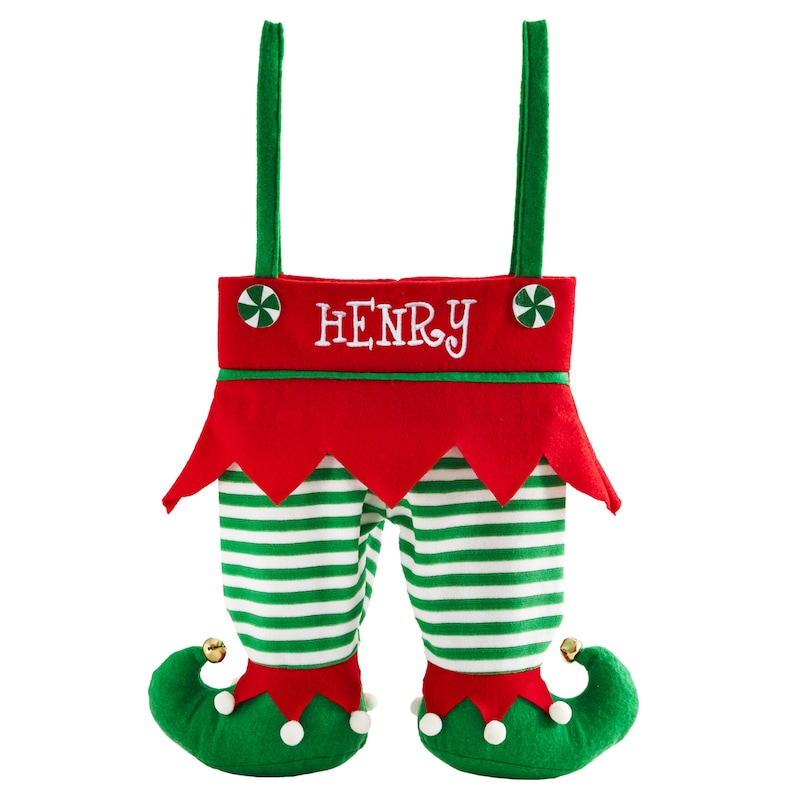 May include: A Christmas stocking shaped like elf legs. The red top has the name "HENRY" embroidered in white. The legs are green and white striped, with green elf shoes and jingle bells.