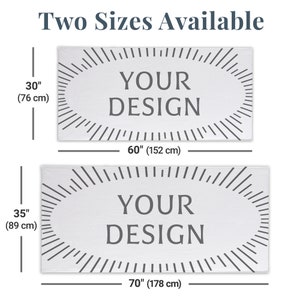 May include: Two sizes of white bath towels with a grey oval design that says "YOUR DESIGN". The smaller towel is 30 inches by 60 inches (76 cm by 152 cm). The larger towel is 35 inches by 70 inches (89 cm by 178 cm).