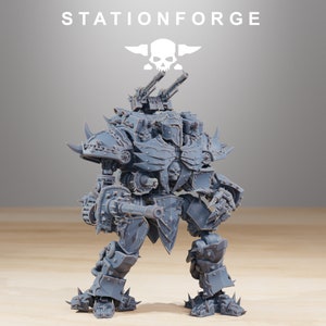 May include: A grey plastic model of a heavily armoured robot with a skull on its chest and a large gun in its right hand. The robot has a large, spiked shield on its left arm and is standing on a wooden surface. The robot is a 3D printed model.