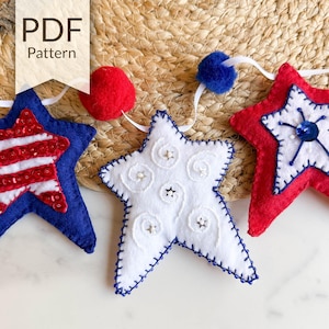 May include: A felt garland with three red, white, and blue stars. The stars are decorated with sequins, embroidery, and beads. The garland is perfect for a patriotic celebration.
