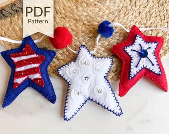 May include: A felt garland with three red, white, and blue stars. The stars are decorated with sequins, embroidery, and beads. The garland is perfect for a patriotic celebration.