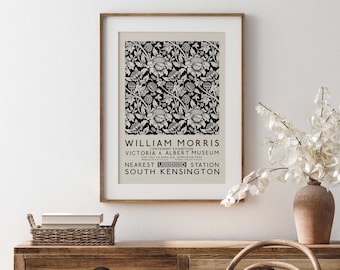 May include: A black and white poster with a floral design. The poster advertises a William Morris Centenary Exhibition at the Victoria & Albert Museum. The text reads "William Morris Centenary Exhibition, Victoria & Albert Museum, Feb. 10th to April 8th, Admission Free, Nearest Underground Station South Kensington."