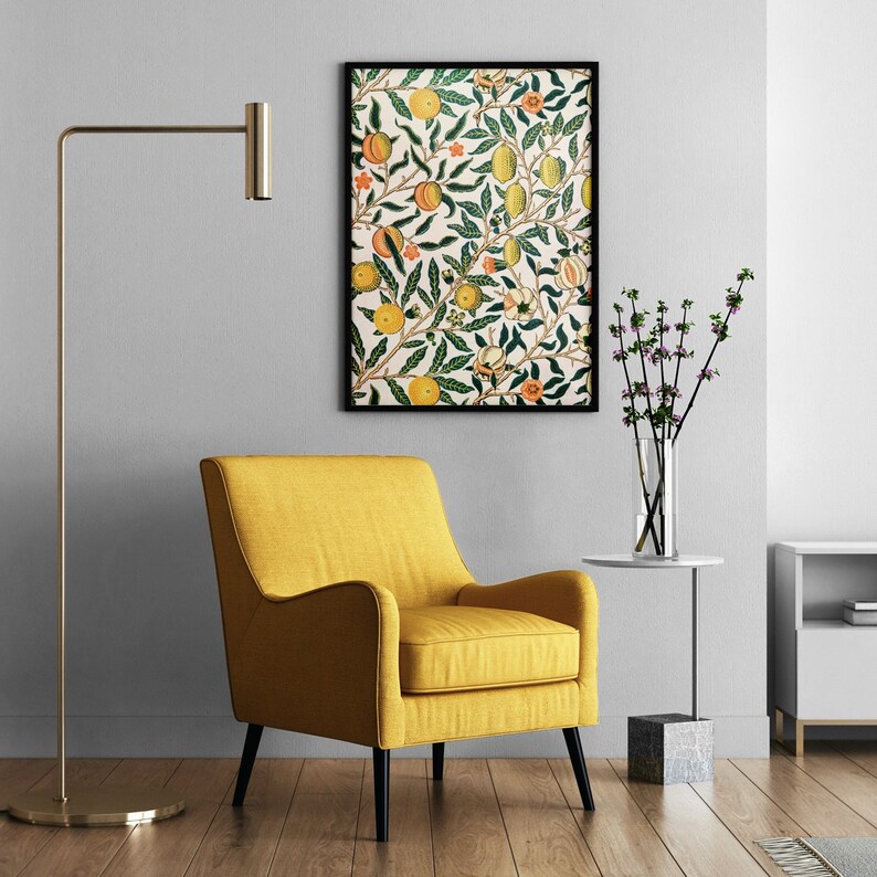 May include: A yellow armchair with black legs sits in front of a white wall with a framed print of a floral pattern with oranges and leaves. A gold floor lamp stands to the left of the chair. A small table with a vase of purple flowers sits to the right of the chair.