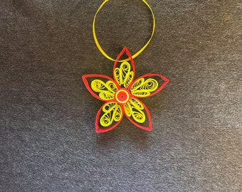 Handmade quilled paper flower ornament.