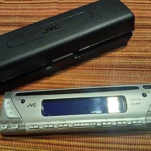 JVC Car Stereo Receiver KD-G110 with CD player from 2005, upgrade your factory stereo. Comes with parts and case as shown.