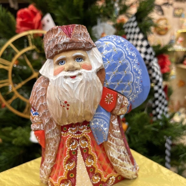 Wooden Santa Claus figurine with a bag