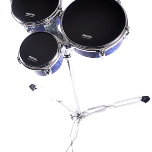 May include: A set of three black drum heads with blue and silver accents. The drum heads are mounted on a silver stand with three legs. The drum heads have the text "MAXTONE" printed on them.