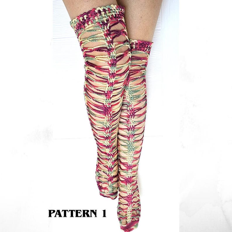 May include: Thigh-high crochet socks featuring an openwork lattice design in variegated shades of magenta, green, and cream. The socks have a solid band at the top and a textured, woven appearance throughout. The text PATTERN 1 is visible.