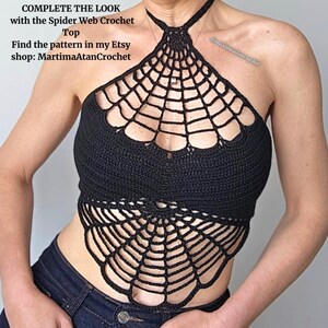 K&ouml;nnte beinhalten: Ein schwarzes H&auml;kel-Neckholder-Top mit Spinnennetz-Muster auf der Brust und am unteren Saum. Der Text lautet: COMPLETE THE LOOK with the Spider Web Crochet Top Find the pattern in my Etsy shop: MartimaAtanCrochet. Das Top hat ein Nackenband.