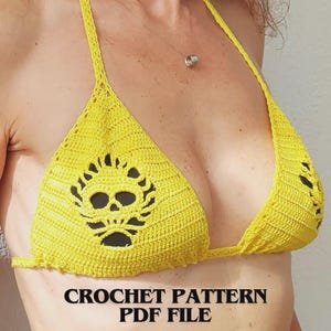 May include: A bright yellow crochet bikini top featuring a prominent skull motif integrated into the center of the triangular cup. The garment includes thin crocheted straps and is labeled as a CROCHET PATTERN PDF FILE.