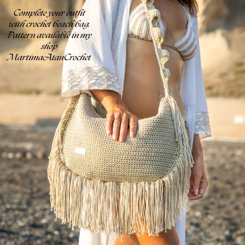May include: A beige crochet beach bag featuring a long shoulder strap with decorative ruffles and a fringe trim along the bottom edge. The text on the image reads: Complete your outfit with crochet beach bag. Pattern available in my shop MartimaAtanCrochet.