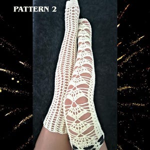 May include: A pair of off-white, thigh-high crochet stockings featuring an intricate, openwork lace pattern. The stockings are labeled with the text PATTERN 2 in the upper left corner. The design consists of repeating geometric shapes.