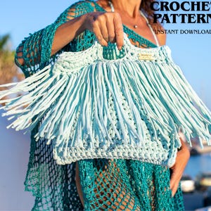 May include: A light blue crochet handbag featuring a dense fringe design on the front, two integrated handles, and a small rectangular label. The text CROCHET PATTERN INSTANT DOWNLOAD is visible in the upper right corner of the image.