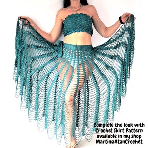 May include: A teal crochet two-piece set consisting of a strapless tube top and a long, open-work skirt with a radiating fan pattern. The text in the image reads: Complete the look with Crochet Skirt Pattern available in my shop MartimaAtanCrochet.