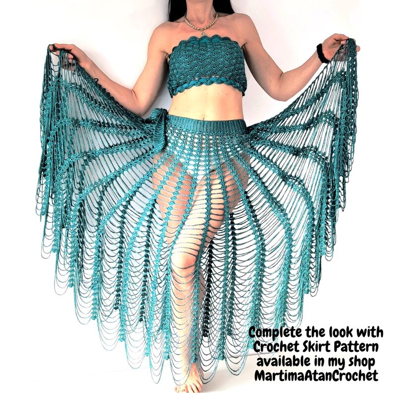 May include: A teal crochet two-piece set consisting of a strapless tube top and a long, open-work skirt with a radiating fan pattern. The text in the image reads: Complete the look with Crochet Skirt Pattern available in my shop MartimaAtanCrochet.