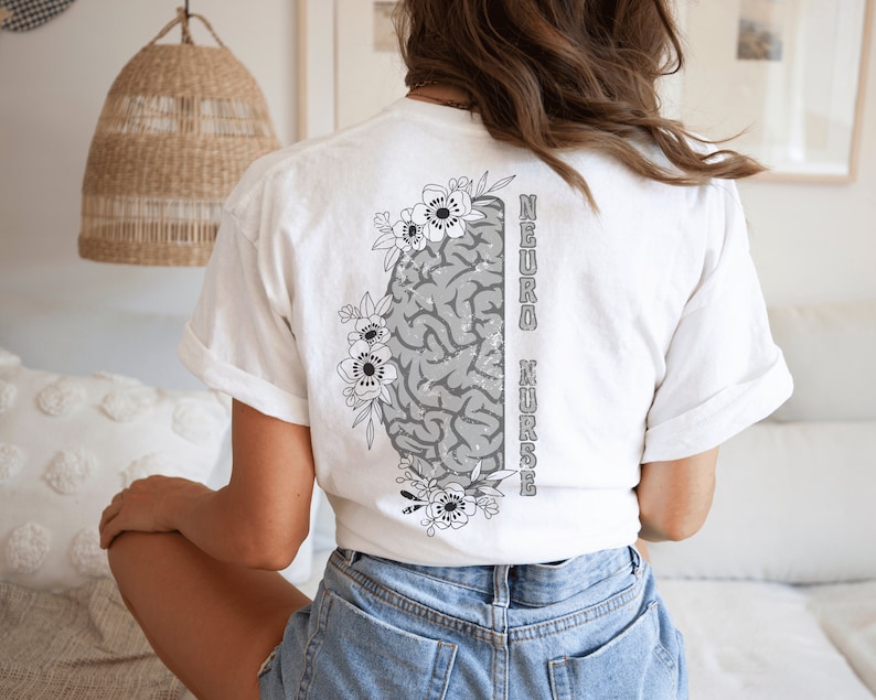 May include: White t-shirt with a gray brain graphic and floral accents. The text "NEURO NURSE" is printed vertically on the right side of the brain graphic.