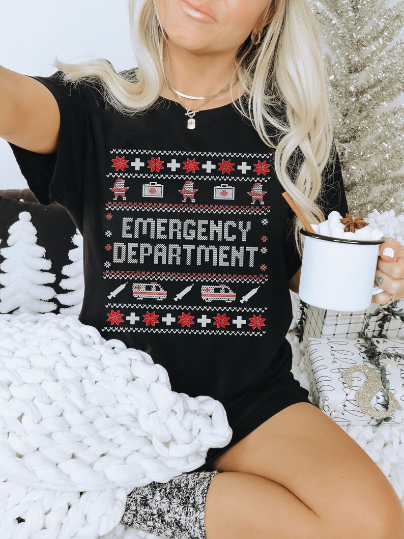 May include: Black Christmas jumper with a red and white snowflake pattern. The jumper has the text "Emergency Department" in red letters.