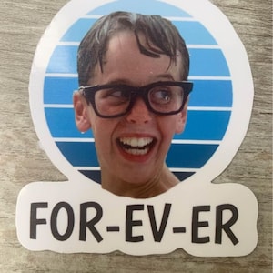 May include: A white sticker with a blue and white striped circle featuring a boy with wet hair wearing glasses and smiling. The text "FOR-EV-ER" is printed below the circle.