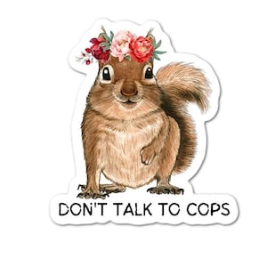 May include: A cute cartoon squirrel wearing a flower crown with the text "Don't Talk To Cops" on a white background.