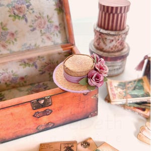 1:12 scale Victorian dollhouse miniature ephemera and accessory set. This printable digital kit features a vintage steamer trunk, floral photo album, personal journal, and over 200 nostalgic paper treasures. Designed by LittleBethMiniature for vintage dollhouse collectors.